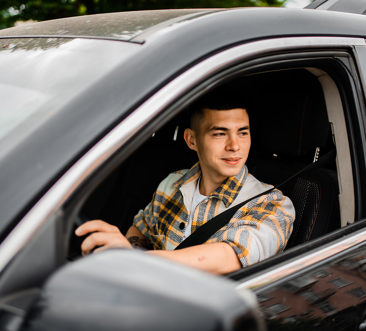 Hand reaching toward a car's touchscreen showing a garage door alert
