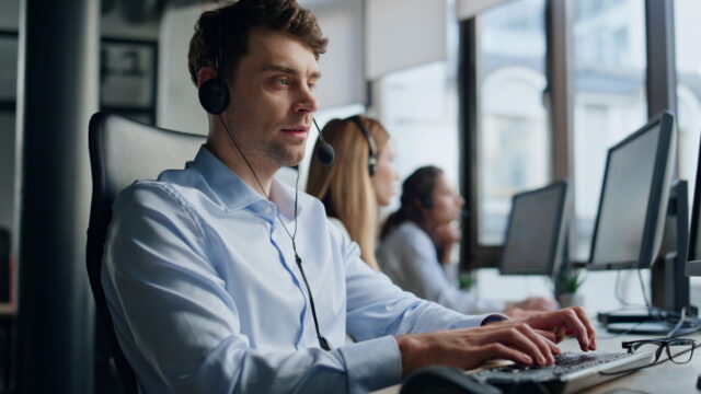 Professional support representative man talking headset helping customer remotely.